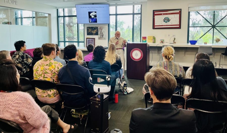 Speaker lecturing a room full of people.