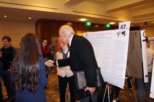 Student and faculty member shake hands
