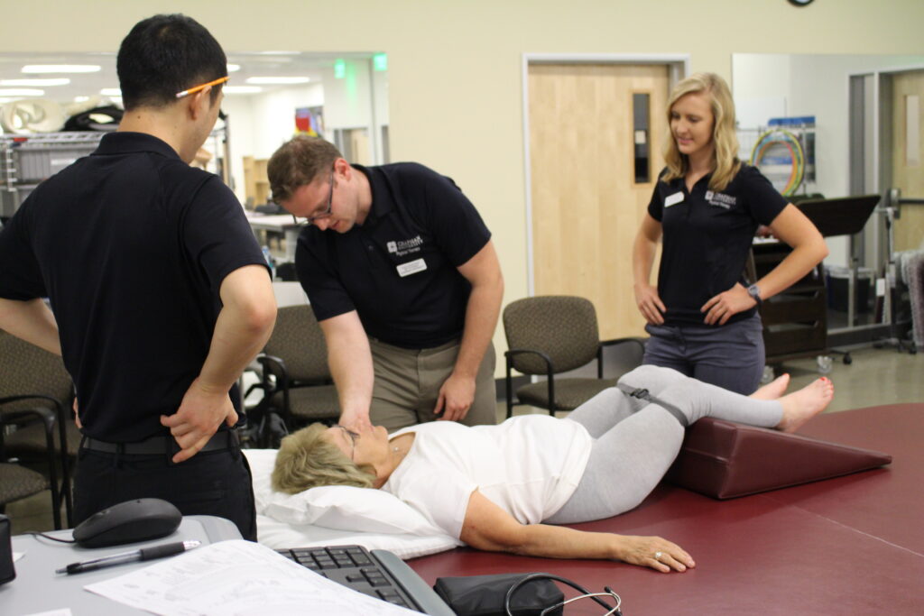 Members of the Department of Physical Therapy stretch out a patient.