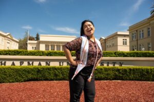 Loura Derro Posing in front of Chapman Sign