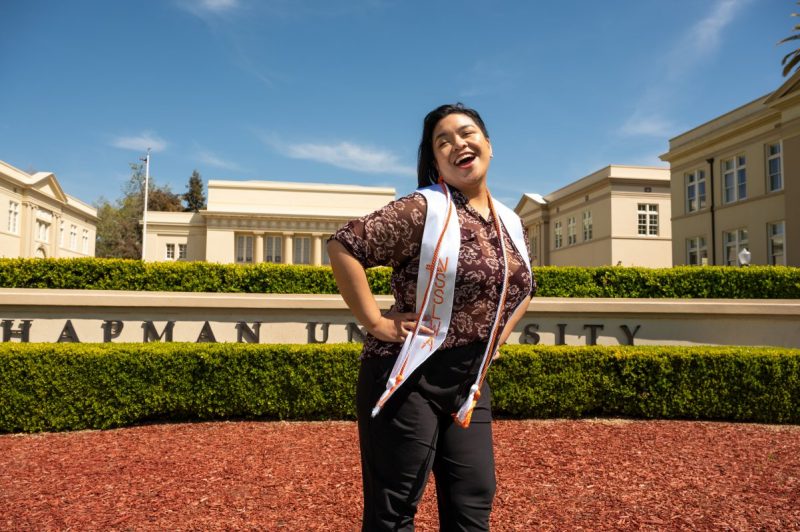 Loura Derro Posing in front of Chapman Sign