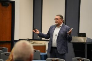 Reza teaching a audience.