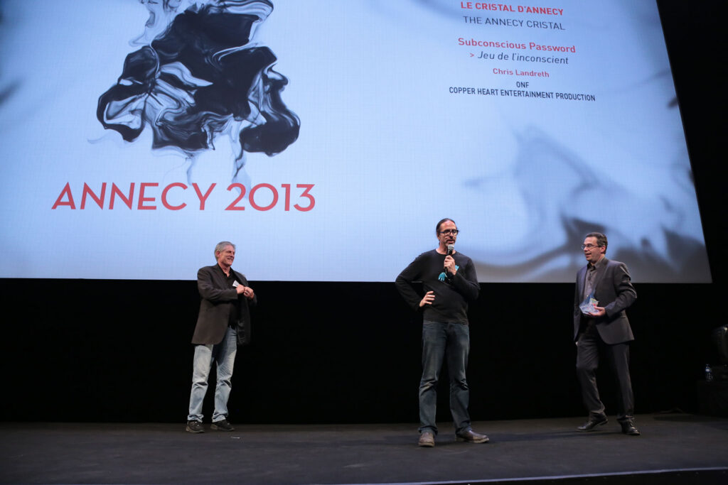 Bill Kroyer, left, presents the coveted Cristal award at Annecy, France, 2013