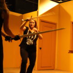 students learning how to sword fight safely as part of interterm stunts class at Dodge College