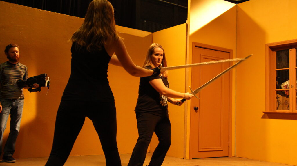 students learning how to sword fight safely as part of interterm stunts class at Dodge College
