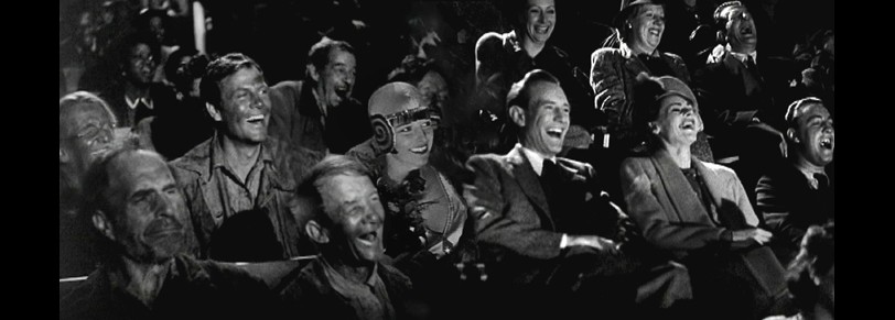 Still of people laughing in an audience