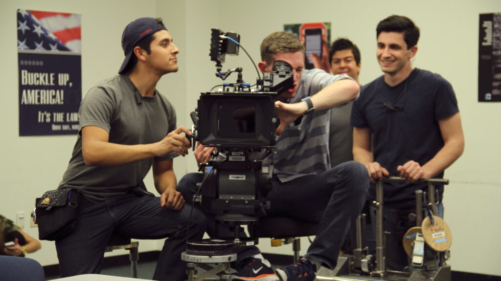Students pose with camera on the set of a Chapman production