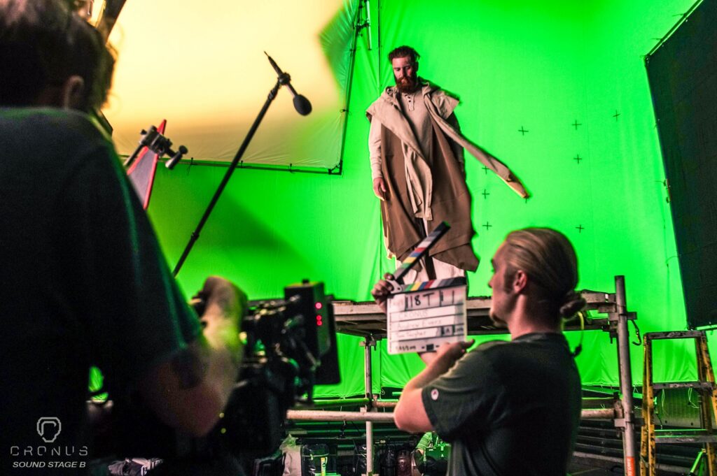 men in robe in front of greenscreen