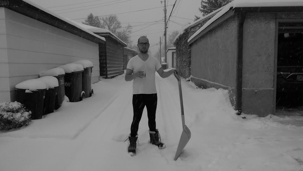 dan olson standing in the snow with shovel