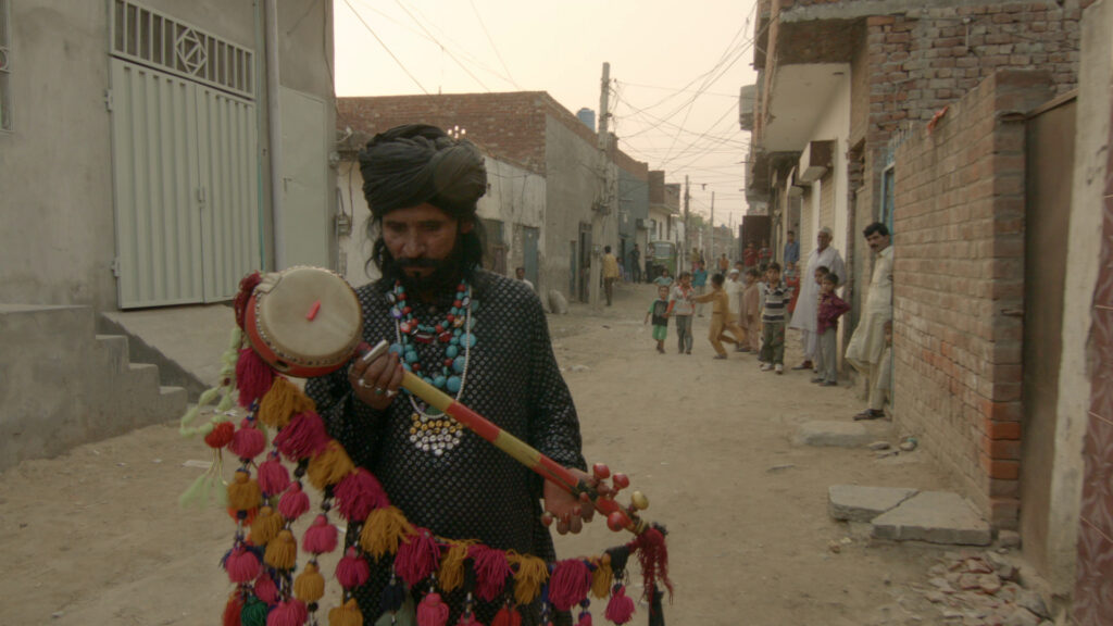 man holding a musical instrument in a foreign land