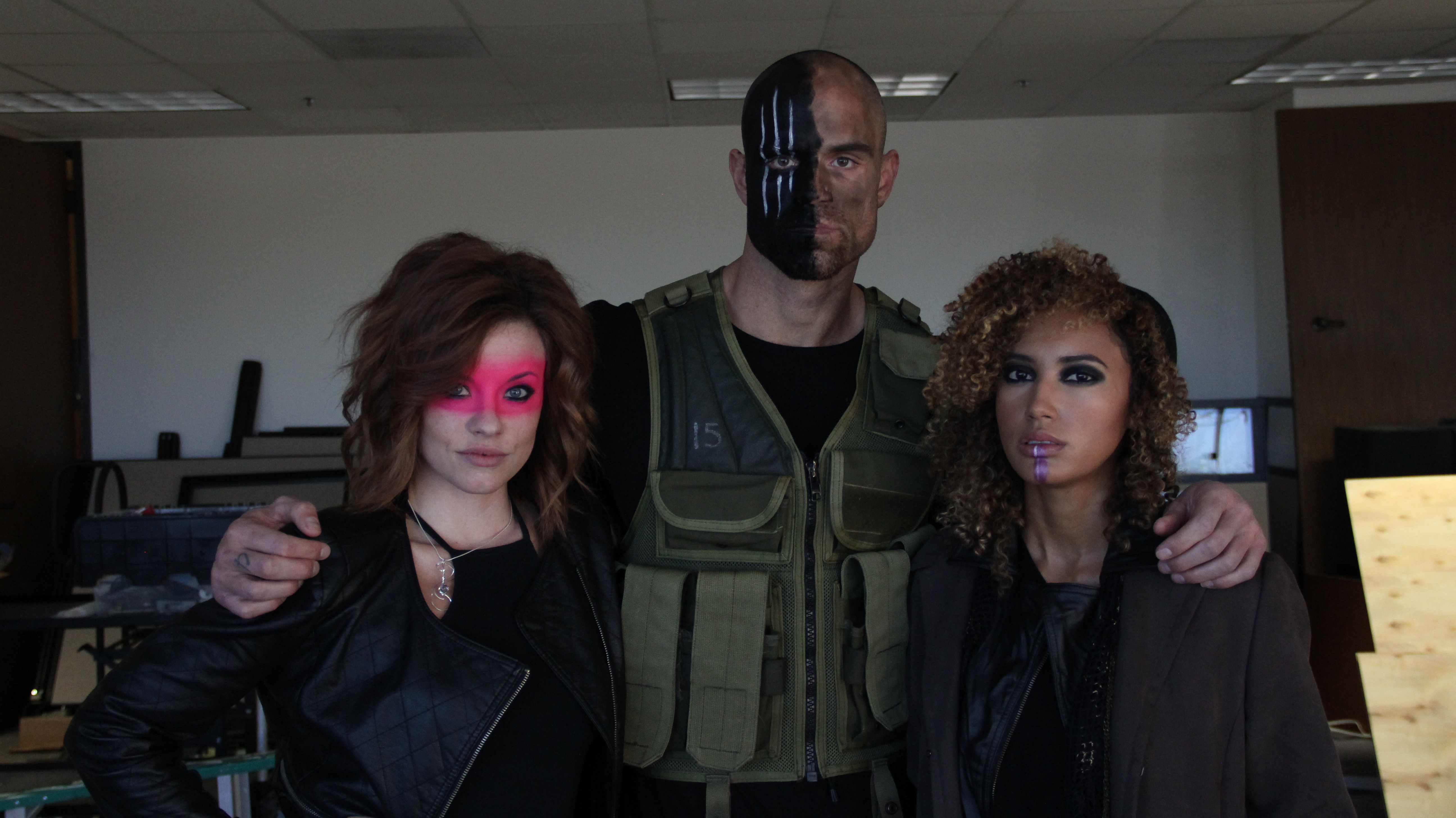 two women and one man in costume standing together