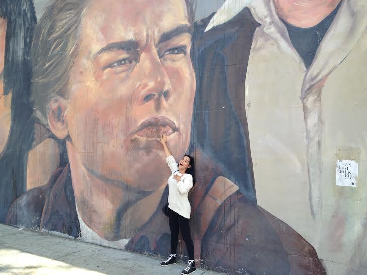 Yashar in front of a mural
