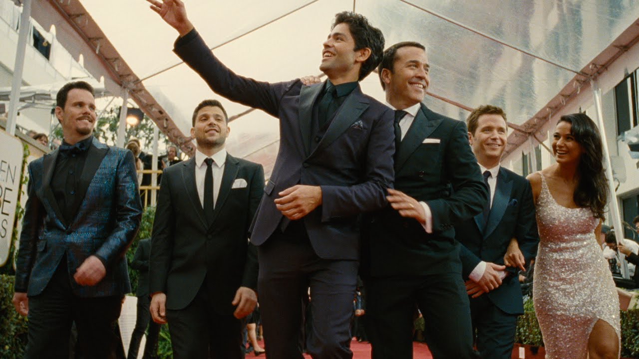 group of people wearing suits walking towards a camera