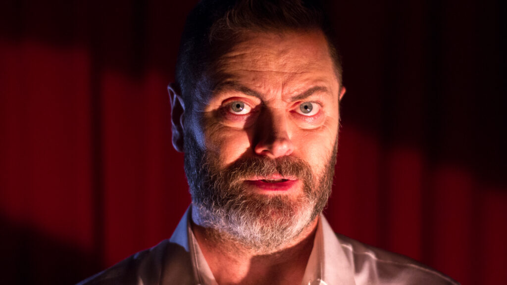 Actor Nick Offerman looks at the camera. Still from, The Greatest, by They Might Be Giants, music video