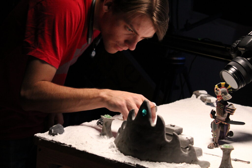 Austin Piko, adjusts elements on the Meraki set.