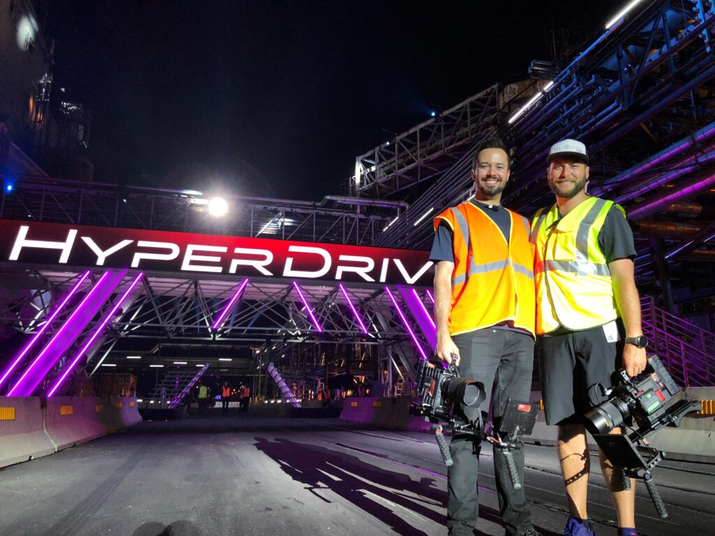 alumni standing in front of show set