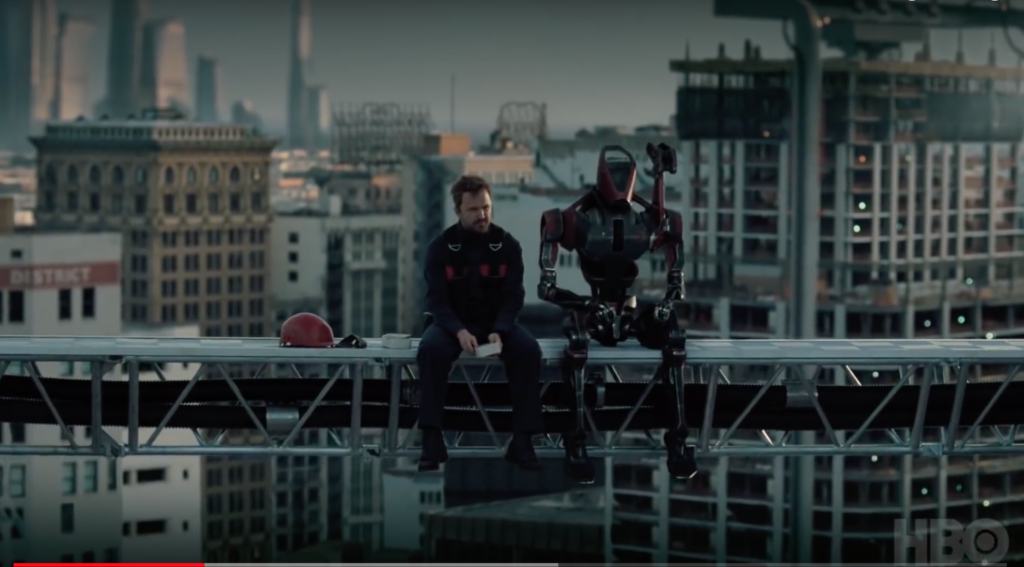 man and robot sit on skyscraper