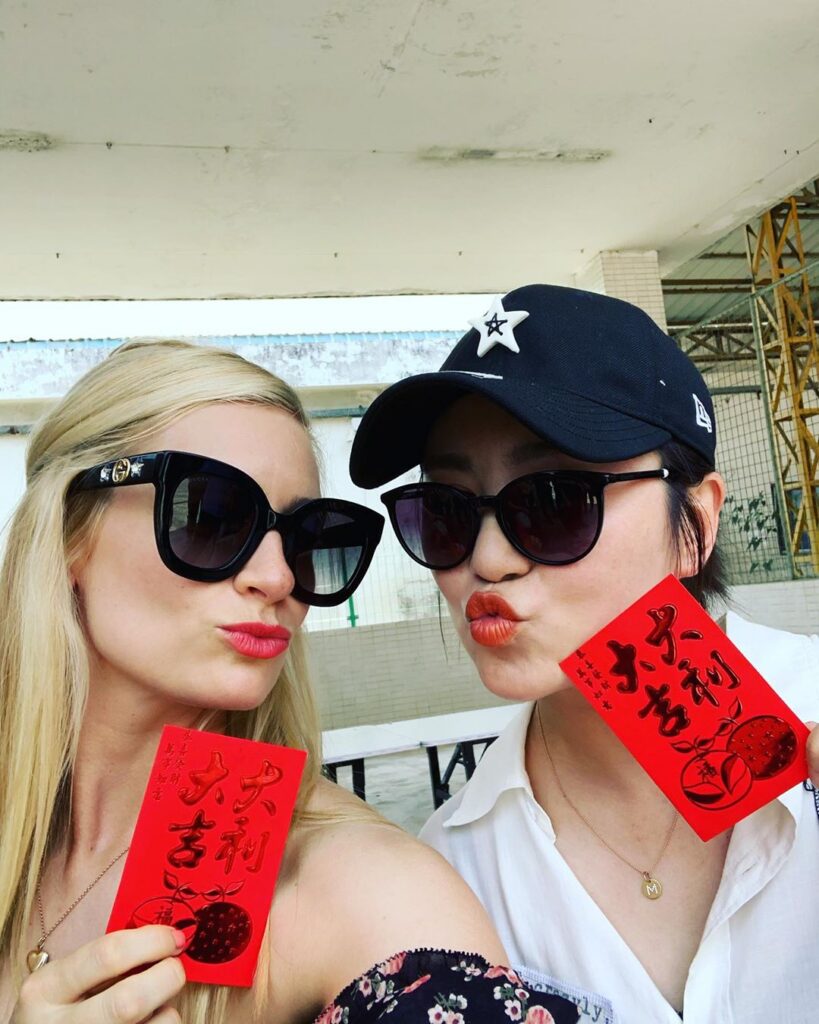 two women holding cards
