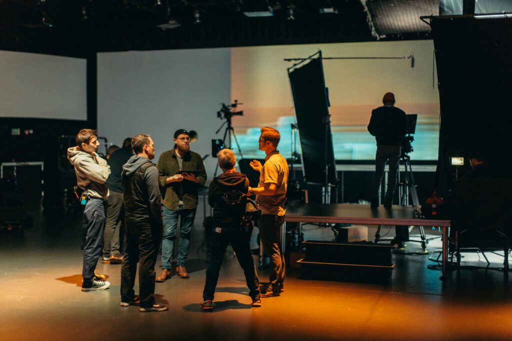 6 people standing on a show set
