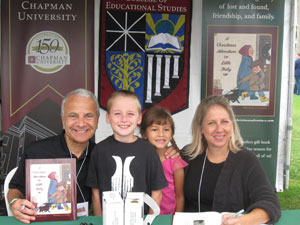 Man with book posing with woman and kids.