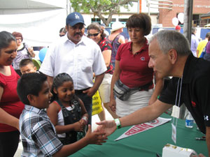 Man shaking hands with kids.