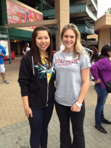 Two women smiling in front of Angel Stadium.