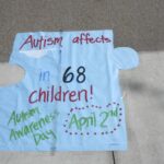Sign shaped like a puzzle piece for autism awareness.