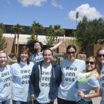People wearing "awareness" t shirts, posing for a photo.