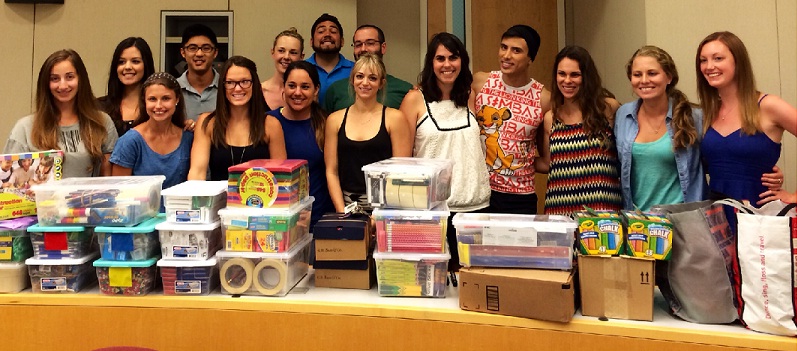 Students with supplies stacked in front.