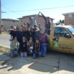 People posing next to a Rebuilding Together truck.