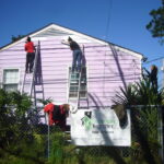 People painting a house in New Orleans.