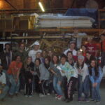 Group of people posing in warehouse.