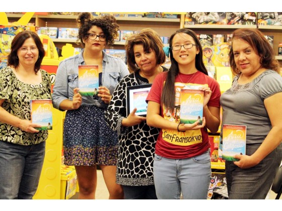 Group of women holding books in a toy store.