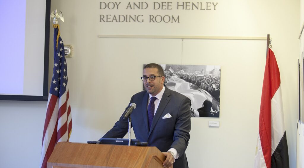 Ahmed Younis at podium giving a speech