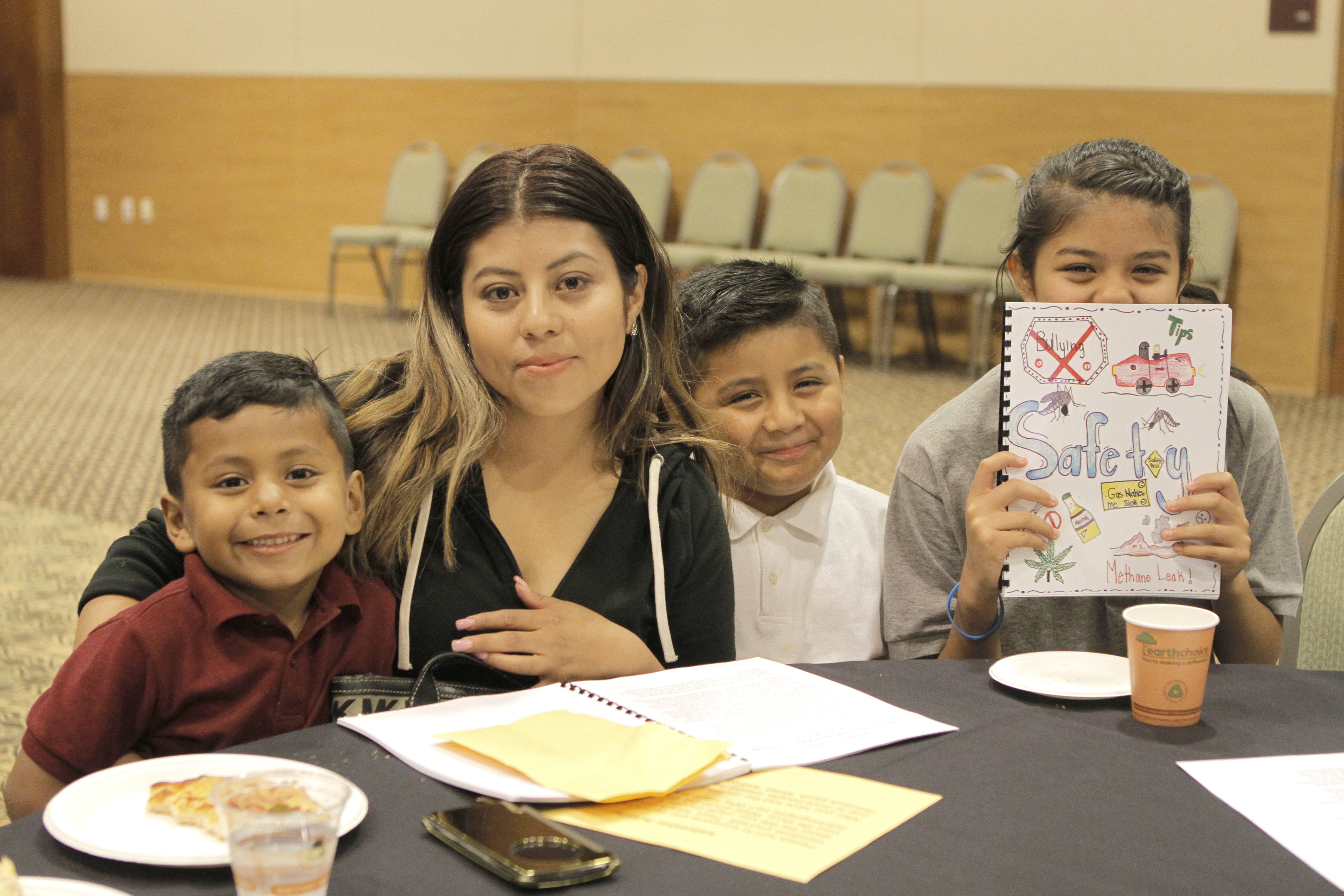 A proud Yorba journalist with her copy of the published anthology, with members of her family.