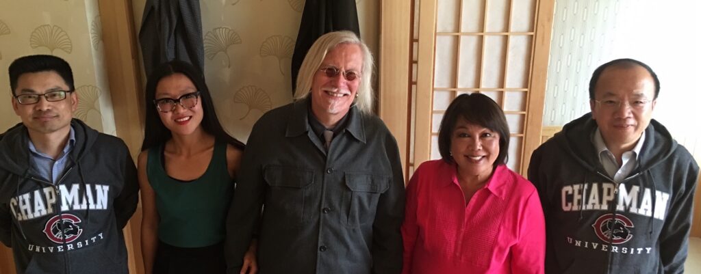 Peter and Suzi with former dean and associate dean in Chapman gear informing us of our honorary directorships to Critical Pedagogy Research center