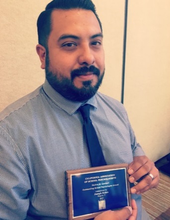 Joe holding award