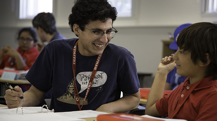 Student credential teacher with child in Chapman reading center