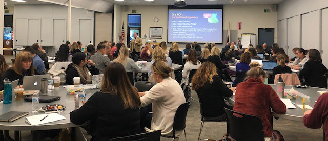 Full room of seated participants at OCDE workshop