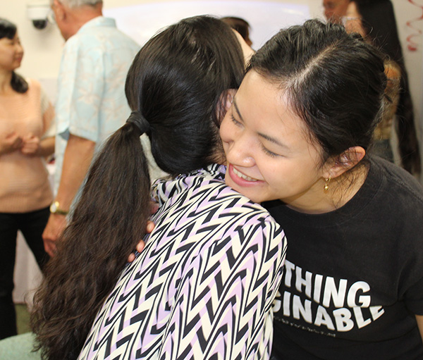 SNU and Chapman staff hugging at SNU farewell party