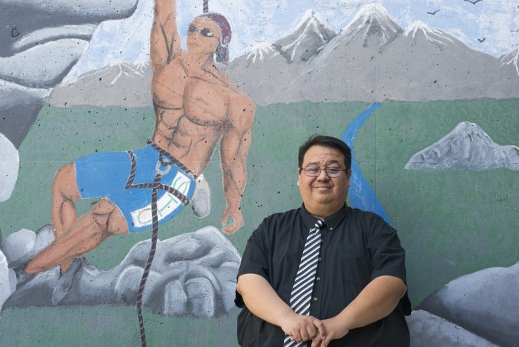 Beau Menchaca in front of mural at Century High School in Santa Ana