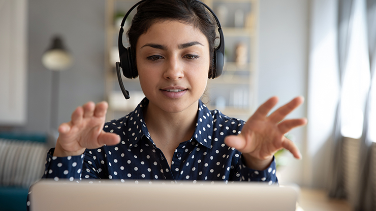 young woman on a laptop with headphones
