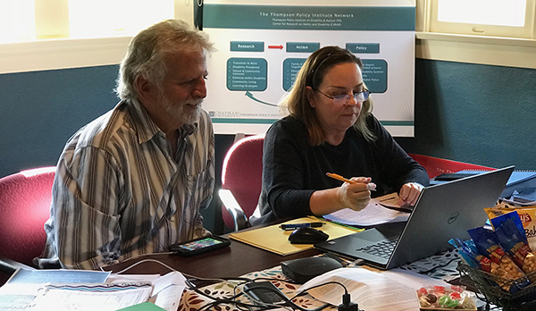 Dr. Richard Rosenberg and Linda O'Neal in Thompson Policy Institute's conference room working on Transition CA resource webpage
