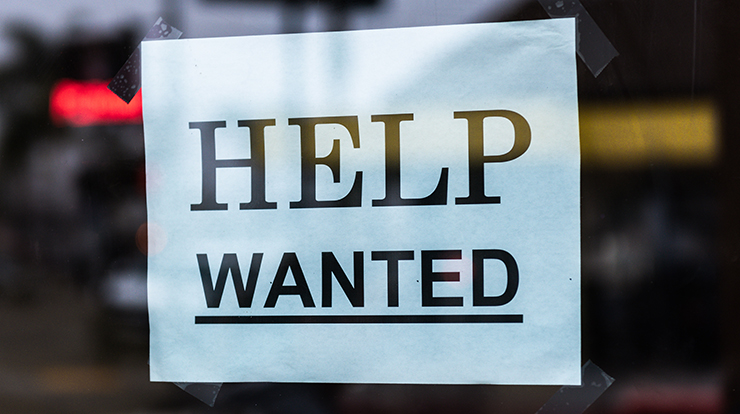 Help Wanted paper sign taped in window