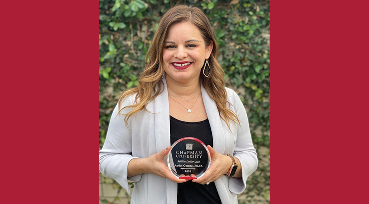Dr. Audri Sandoval Gomez holding Million Dollar Award