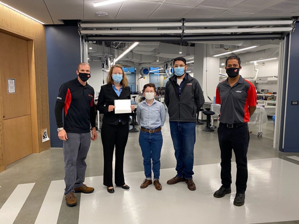 Nicole Wagner receiving check from Gene Haas Foundation
