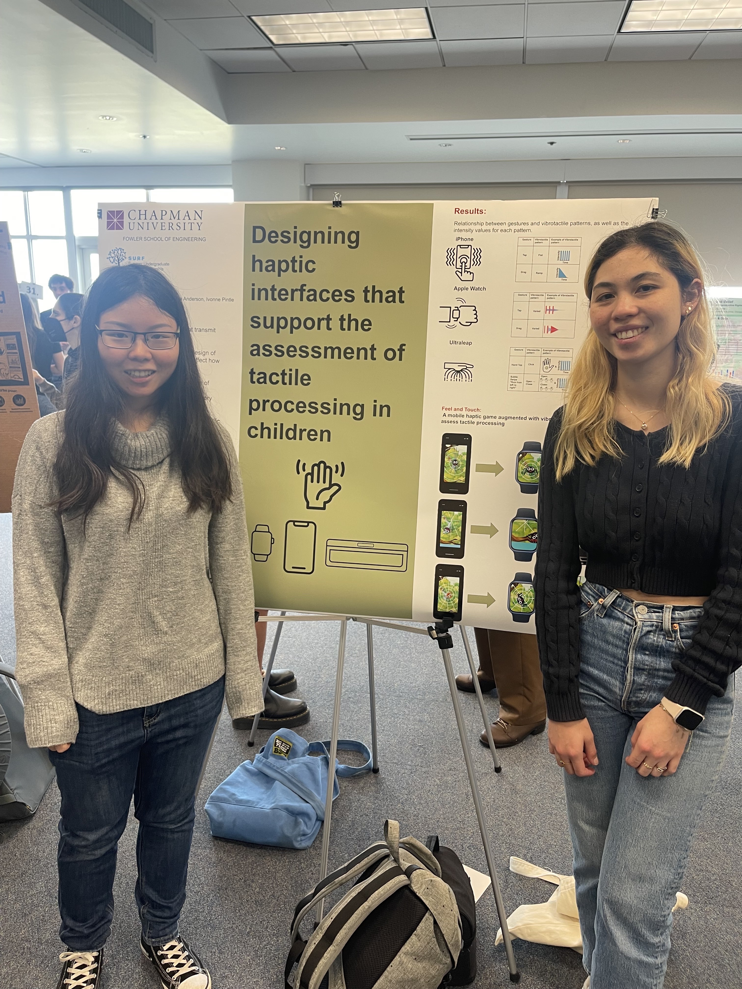 Two students standing in front of research poster