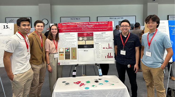 A group of five students standing in front of their research poster. 