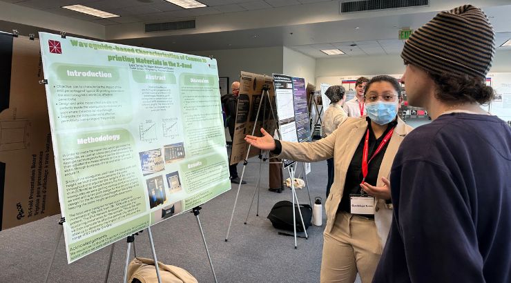 Engineering student explaining their research during the research symposium. 