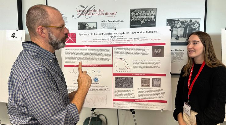 Dr. Andrew Lyon and a female student discussing their research among themselves. 
